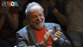 Former Brazilian president Luiz Inacio Lula da Silva applauds during a rally of Brazilian leftist parties at Circo Voador in Rio de Janeiro, Brazil, on April 02, 2018. /AFP PHOTO / MAURO PIMENTEL 