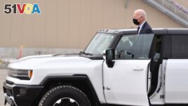 US President Joe Biden test drives a GMC Hummer EV as he tours the General Motors Factory ZERO electric vehicle assembly plant in Detroit, Michigan on November 17, 2021. (MANDEL NGAN / AFP)