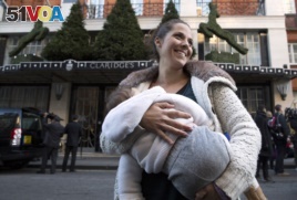 This protester feeds her baby in front of a famous London hotel during a protest in support of breastfeeding in public, 2014. REUTERS/Neil Hall