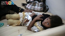 FILE - A girl is treated for suspected cholera infection at a hospital in Sanaa, Yemen, Saturday, Jul. 1, 2017.