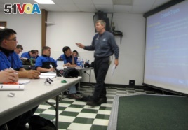 In this June 30, 2009 file photo, Larry Wostenberg teaches an engine management systems class at the WyoTech technical school, which was operated by Corinthian Colleges Inc, at their campus in Laramie, Wyoming