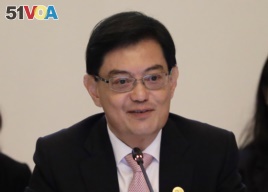 FILE - In this April 6, 2018, file photo, Singapore's Finance Minister Heng Swee Keat delivers his opening address at the start of the ASEAN Finance Ministers' Meetings in Singapore.