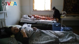 Coronavirus patients lie in an infectious diseases clinic in Stepanakert in the separatist region of Nagorno-Karabakh, Tuesday, Oct. 20, 2020.