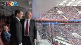 Russian President Vladimir Putin, right, and Russian Prime Minister Dmitry Medvedev look at the field during the match between Russia and Saudi Arabia which opens the 2018 soccer World Cup, at the Luzhniki stadium in Moscow, Russia.