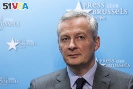 FILE - France's Finance and Economy Minister Bruno Le Maire speaks during a media conference regarding steel tariffs in Brussels, March 12, 2018.