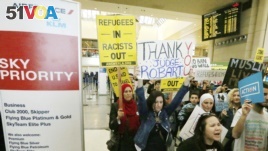 Demonstrators opposed to President Trump's travel ban march through Tom Bradley International Terminal at Los Angeles International Airport, Feb. 4, 2017. One sign thanks federal judge James L. Robart, who issued a stay of the order.