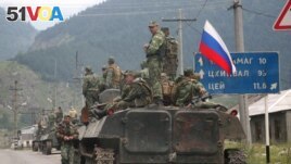 A column of Russian armored vehicles move through North Ossetia towards the breakaway republic of South Ossetia's capital Tskhinvali. (File)