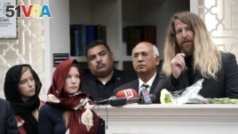 Jason Cogburn, right, speaks as his wife, Joleen, left, and daughter, Jaelyn, far left, listen during a funeral for Pakistani exchange student Sabika Sheikh, who was killed in the Santa Fe High School shooting.