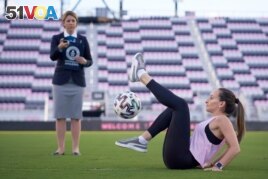 Laura Biondo, 32, from Venezuela, breaks the new Guinness World Record for Most sit-down football crossovers in 30 seconds (female) in Fort Lauderdale, Florida, U.S., in this undated handout photo. (Courtesy of Guinness World Records 2021/Juan Zabala)