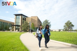 Students walk across campus at Valencia College in Orlando, Florida.