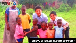 Japanese interns Tomoyuki Tsutsui and Keitaro Kakoi  with residents of Kisumu, Kenya, where a water project will bring clean water to residents. 