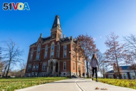 A student walks across the East Campus of DePauw University in Greencastle, Indiana.