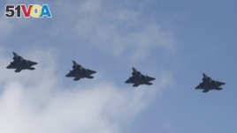 Four U.S. F-22 stealth fighters fly over South Korea. It was the latest show of strength since North Korea's nuclear and missile tests.