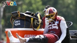 Washington Redskins linebacker Reuben Foster rides a cart off the field after suffering an injury during a practice at the team's NFL football practice facility, Monday, May 20, 2019, in Ashburn, Va. (AP Photo/Patrick Semansky)
