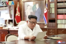 North Korean leader Kim Jong Un reads a letter from U.S. President Donald Trump, in Pyongyang, North Korea, in this picture released by North Korea's Korean Central News Agency, June 22, 2019.