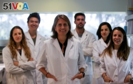 Marina Simian, a medical researcher, poses for a picture with members of her team May 9, 2019. (REUTERS/Agustin Marcarian)