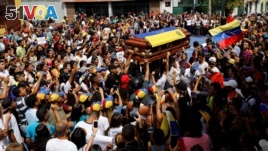 Mourners carry the coffin of Neomar Lander, who died during a protest against Venezuelan President Nicolas Maduro's government, during his funeral in Guarenas, Venezuela, June 9, 2017.