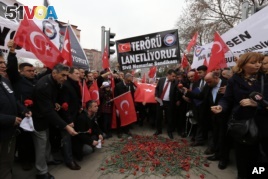 Turkish civil servants hold a banner that reads 