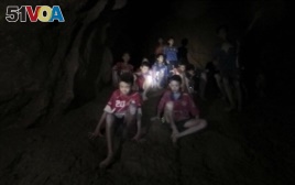 This Monday, July 2, 2018, photo released by Tham Luang Rescue Operation Center, shows the boys and their soccer coach as they were found in a partially flooded cave.