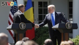 President Donald Trump with Romanian President Klaus Werner Iohannis shake hands during their joint news conference in the Rose Garden of the White House in Washington, Friday, June 9, 2017. (AP Photo/Pablo Martinez Monsivais)