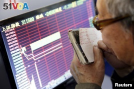 An investor looks at a screen showing stock information, after the new circuit breaker mechanism suspended today's stocks trading, in Shanghai, China, Jan. 7, 2016. (REUTERS/China Daily)