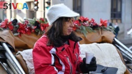 Coachwoman Nathalie Matte, 52, who will lose her job when Montreal's horse-drawn carriages are taken off the roads Dec. 31, waits for passengers in Montreal, Quebec, Canada, Dec. 22, 2019. (AFP)