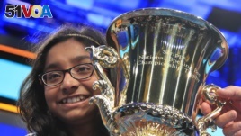 Ananya Vinay, 12, from Fresno, Calif., holds the trophy after winning the 90th Scripps National Spelling Bee, in Oxon Hill, Md., June 1, 2017.