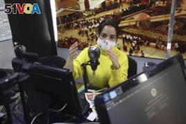 Diana Lopez presents a one-hour class through Bacata Stereo radio station in Funza, Colombia, Wednesday, May 13, 2020.