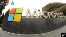 The Microsoft Corp. logo appears outside the Microsoft Visitor Center in Redmond, Washington, July 3, 2014. In a lawsuit filed April 14, 2016, Microsoft is suing the US government over a federal law that lets authorities examine customers' emails or online files without the customers' knowledge. The lawsuit comes as the tech industry is increasingly butting heads with U.S. officials over customers' privacy rights. (AP Photo Ted S. Warren, File)