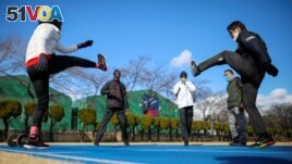 Athletes from South Sudan, Lucia Moris, Akoon Akoon and Michael Machiek, take part in their training session with Japanese trainers on Jan. 29, 2021, in preparation for the Tokyo 2020 Olympic Games. (REUTERS/Issei Kato)