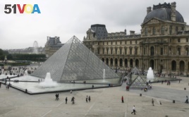 FILE - General view of the Louvre Museum in Paris, with the glass Pyramid entrance designed by Chinese-born U.S. architect I.M. Pei, Aug. 6, 2007.