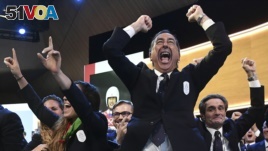 Mayor of Milan Giuseppe Sala and members of Milan-Cortina delegation celebrate after winning the bid to host the 2026 Winter Olympic Games. (Philippe Lopez/Pool via AP)