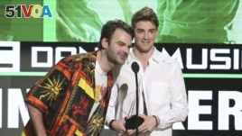 Alex Pall, left, and Andrew Taggart, of The Chainsmokers, accept the award for favorite artist - electronic dance music at the American Music Awards at the Microsoft Theater, Nov. 20, 2016, in Los Angeles.