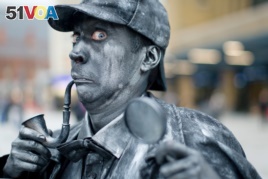 A performer poses as a Sherlock Holmes human statue in London, September 2013.