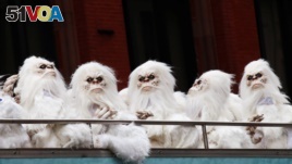 FILE - Actors dressed as a yeti ride a tour bus in Manhattan, New York City, Oct. 4, 2016.