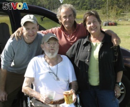 In this Sept. 29, 2009 photo provided by Betsy McNair, Robert McNair, center, poses with his children from left to right, Paul, Mark, and Betsy on the Eastern Shore of Virginia. (Courtesy of Betsy McNair via AP)