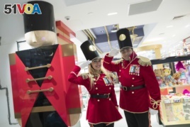 In this Tuesday, Nov. 13, 2018 photo, FAO Schwarz toy soldiers dressed in uniforms designed by model Gigi Hadid pose for a photo during a media preview of the new FAO Schwarz store at Rockefeller Center in New York. (AP Photo/Mary Altaffer)