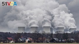In this January 6, 2019 file photo water vapor rises from the cooling towers of the Joenschwalde coal-fired power plant of Lausitz Energie Bergbau AG (LEAG) in Brandenburg, Germany. (Patrick Pleul/dpa via AP)