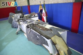 Debris from what Iran's Revolutionary Guard aerospace division describes as the U.S. drone which was shot down on Thursday is displayed in Tehran, Iran, Friday, June 21, 2019. (Meghdad Madadi/ Tasnim News Agency via AP)