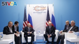 President Donald Trump meets with Russian President Vladimir Putin at the G-20 Summit in Hamburg, July 7, 2017. Russian Foreign Minister Sergey Lavrov is at left, Secretary of State Rex Tillerson is at right.