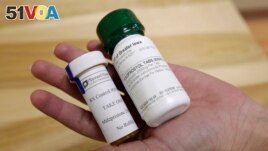 FILE - Bottles of abortion pills mifepristone, left, and misoprostol, right, at a health center in Des Moines, Iowa, Sept. 22, 2010. A federal appeals court has preserved access to an abortion drug for now with some restrictions. (AP Photo/Charlie Neibergall, File)