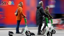People ride electric scooters by Lime sharing service, on the eve of a public vote on whether or not to ban rental electric scooters, in Paris, France, April 1, 2023. (REUTERS/Sarah Meyssonnier)