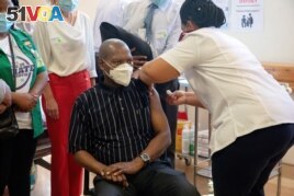 FILE - South African Health Minister Zweli Mkhize receives the Johnson and Johnson coronavirus disease (COVID-19) vaccination at the Khayelitsha Hospital near Cape Town, South Africa, Feb. 17, 2021.