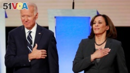 FILE - Former Vice President Joe Biden and U.S. Senator Kamala Harris take the stage before the start of the second night of the second U.S. 2020 presidential Democratic candidates debate in Detroit, Michigan, U.S., July 31, 2019.