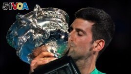 FILE - Serbia's Novak Djokovic kisses the Norman Brookes Challenge Cup after defeating Russia's Daniil Medvedev in the men's singles final at the Australian Open tennis championship in Melbourne, Australia Feb. 21, 2021.(AP Photo/Mark Dadswell)