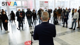 FILE - Members of the media listen as Peter Feldmann, mayor of the city of Frankfurt, speaks during his visit to a vaccination center as the coronavirus outbreak continues in Frankfurt, Germany, Dec. 17, 2020. (REUTERS)