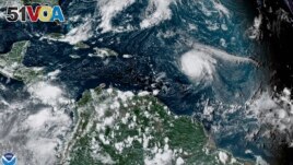 This satellite image shows Hurricane Sam, center right, in the Atlantic Ocean, Monday, Sept. 27, 2021. National Oceanic and Atmospheric Administration's Atlantic hurricane season forecast calls for 14 to 21 named storms, with six to 10 becoming hurricanes.