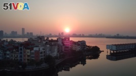 The sun sets in Hanoi, where growing demand for housing puts Vietnam at risk of the affordability issues seen in countries from Brazil to Ireland. 