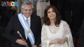 Argentina's new President Alberto Fernandez and Vice President Cristina Fernandez de Kirchner smile after they take the oath of office at the Congress in Buenos Aires, Argentina, Dec. 10, 2019. 