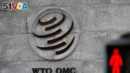 File - a picture of the World Trade Organization (WTO) headquarters next to a stop sign, in Geneva, Switzerland.
